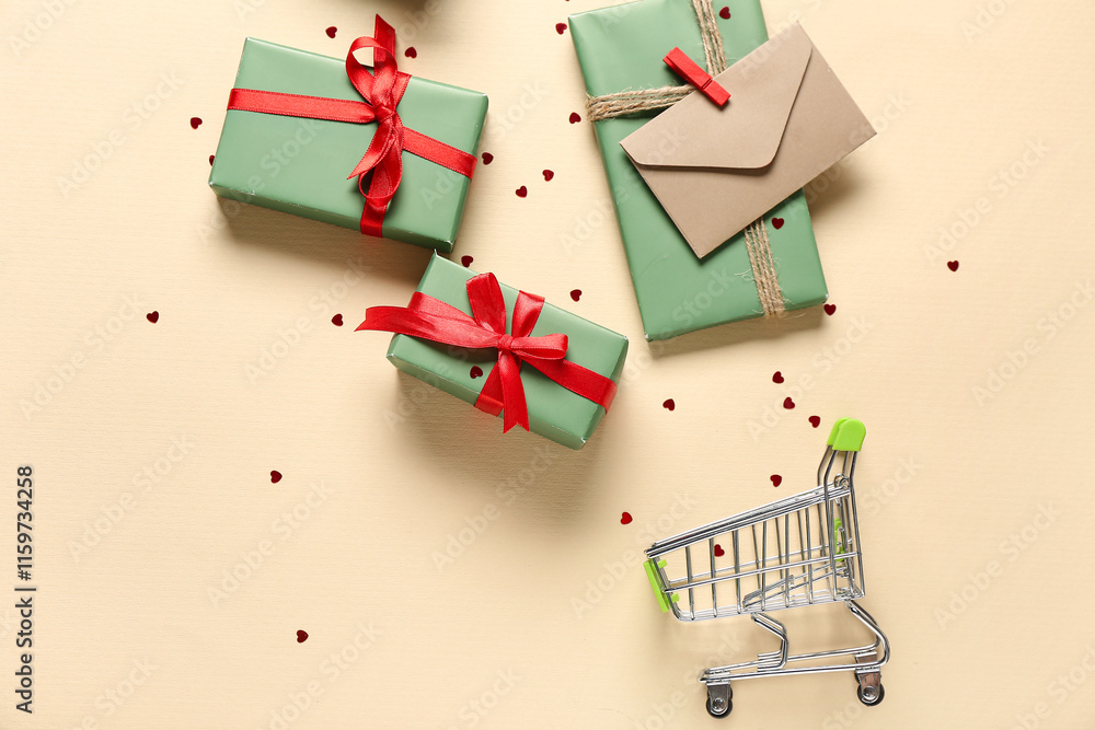 Small shopping cart with gift boxes, envelope and confetti on beige background. Valentine's Day celebration