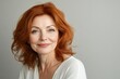 © LimeSky - Mature woman with smooth skin smiling against a light backdrop