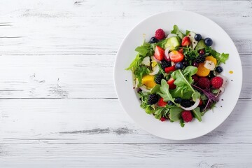 Wall Mural - Summer fruit and berry salad on a white wooden surface with selective focus