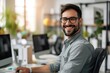© Alexandr Efimov - A happy and efficient worker in a modern office environment with computer equipment.