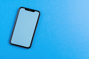 close up of empty smartphone screen on blue background, showcasing its sleek design and modern technology