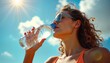 © Maryna - Woman drinks water outdoors under bright hot summer sun. Wears sunglasses, orange swimsuit. Cool drink quenches thirst on hot day. Summertime outdoor activity. Woman enjoys refreshing drink. Summer