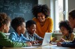 © Maryna - African American teacher guides diverse group of children in lesson. Study computer program on laptop at classroom table. Students interact with teacher, engage in discussion. Classroom environment