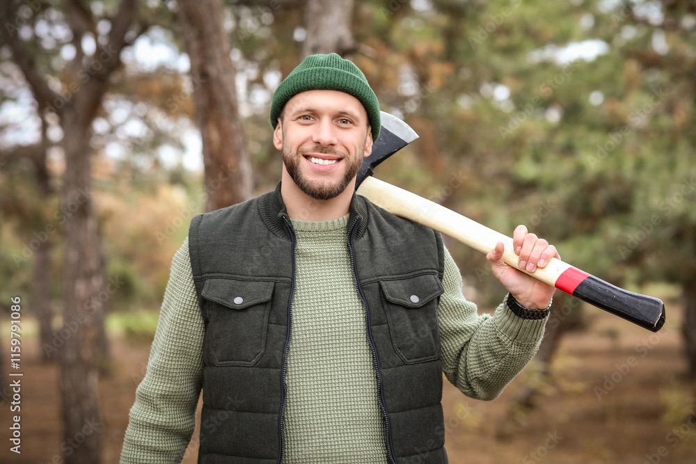 Male lumberjack with axe in forest