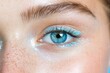© pisan - This striking close-up features a single, mesmerizing blue eye enhanced with shimmering, light-blue glitter, perfect for a bold and imaginative beauty statement it evokes a futuristic singles night