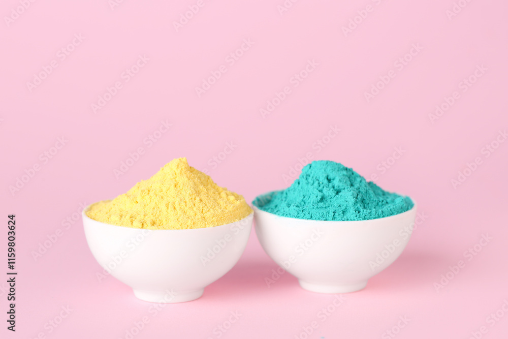 Bowls of powder pigments on pink background