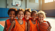 © Maryna - Group of smiling children in orange sports jerseys. Kids play basketball on sports field on sunny day. Happy, look at camera. Children enjoy summer camp activities. Positive photo about friendship,