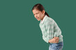 © Pixel-Shot - Teenage girl with appendicitis on green background