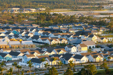 Wall Mural - Wooden frames of new cheap American homes under construction. Development of residential housing in the USA