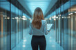 © Extra - A woman is walking down a hallway with a clipboard in her hand Generative Ai.