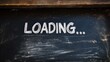 © milenialdesastudio - Chalkboard with the word 'Loading...' written in white chalk.