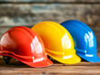 © thanakrit - Colorful Safety Helmets on a Wooden Surface for Construction and Industrial Use