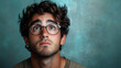 © Siasart - Young Man with Glasses Looks Upward in Wonder Against a Teal Backdrop