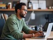 © Vitaliy - Focused Man Working on Laptop at Desk