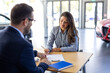 © Graphicroyalty - Young woman signing car insurance document or lease paper contract or agreement. Buying or selling new or used vehicle with car keys on table.