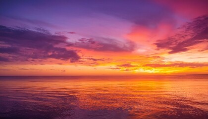 Canvas Print - Fiery sunset over calm ocean waters.  Shades of orange, purple, and pink paint the sky.