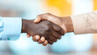 © Supapich - close up of two hands shaking in professional setting, symbolizing agreement and collaboration