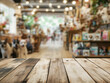 © zetrum - A vintage-styled wooden table showcasing pet adoption information and supplies, in front of a softly blurred background of a bustling pet shop filled with joyful animals, promoting pet adoption