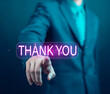 © WICHAI - Businessman using laptop and showing thank you message. Concept of congratulation, appreciation, presentation from digital technology. Thank you in business and gratitude.
