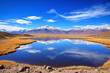 © He - Landscape with lake, mountains and sparse vegetation