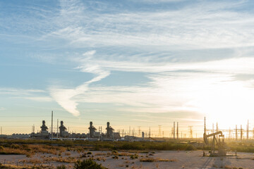 Oil wells in Texas early in the morning with sunrise in background