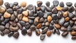 © FairValue Stock - Collection of small pebbles spread across a white surface
