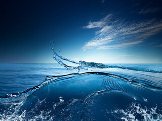 Poster - Dynamic ocean water splash against a vibrant blue sky.  Sunlight glints off the waves creating a serene yet powerful image of nature's beauty.