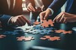 © Alla - Group of people working together to complete a puzzle