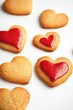 © Alla - A plate of freshly baked heart-shaped cookies with vibrant red icing, perfect for decorating or gifting