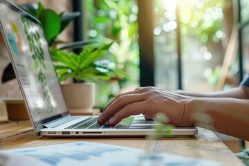 Designer working on laptop for web design concept.