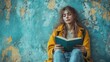 © kaiserseeing - Young Woman Reading Book Against Colorful Urban Wall