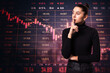 © Who is Danny - Businesswoman pondering in front of a declining stock market chart.