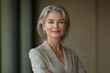© Lumina Frame - Happy mature business woman leader standing in office looking away. Smiling confident older middle aged professional lady corporate leader, senior female executive or entrepreneur, Generative AI