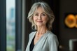 © Lumina Frame - Happy mature business woman leader standing in office looking away. Smiling confident older middle aged professional lady corporate leader, senior female executive or entrepreneur, Generative AI