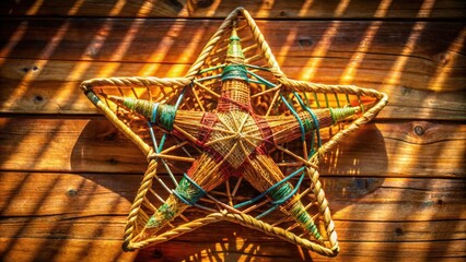 Aufkleber - A woven star shape with vibrant colors is placed against a wooden surface with striped shadows cast by sunlight