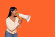 © Iryna - Woman passionately advocating with a megaphone against a vibrant orange background