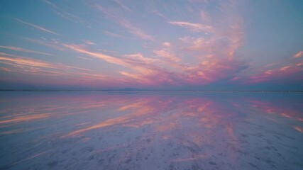 Aufkleber - Stunning sunset over a tranquil salt flat reflecting vibrant colors of the sky at dusk