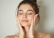 © Joedifries - Portrait of a young woman with glowing skin, light makeup, applying skincare products in a beauty-focused, pastel-colored environment