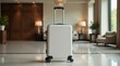 © Александр Бердюгин - A sleek black suitcase stands in a bright hotel lobby, ready for travel, surrounded by stylish chairs and vibrant plants