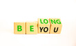 © Dzmitry - Belonging and belong symbol. Concept words Be you Belong on beautiful wooden block. Beautiful white table white background. Business motivational belonging and belong concept. Copy space.
