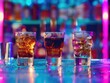 © Alexandr - Three mixed alcoholic drinks with ice in clear glasses on a shelf of a dimly lit bar.