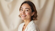 © AlenaSi - Smiling woman in casual outfit against soft background