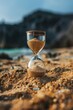 © Oleg - An hourglass filled with sand, sitting on a beach, evoking the concept of time and holidays.