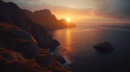 Wall Mural - Stunning sunset view over the calm ocean and rocky coastline. The sun sets behind the mountains, casting a warm glow over the water and creating a serene atmosphere.