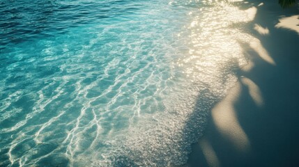 Wall Mural - Serene beach view with gentle waves touching the shore. The sun reflects on clear blue water, creating a peaceful atmosphere for relaxation and enjoyment.