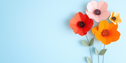 Canvas Print - A blue background with a bunch of paper flowers. The flowers are orange, red, and yellow