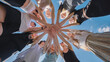 © Довидович Михаил - High school students unite in a circle, clasping hands under a vibrant blue sky, representing teamwork, solidarity, and cooperation