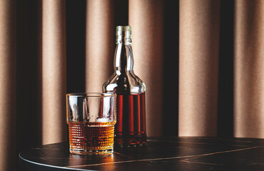 Sticker - Bourbon, whiskey or scotch in glass with bottle. Lifestyle photo on marble table with textile curtain background