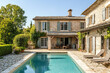© gamespirit - Picturesque stone villa with a serene pool set in lush greenery under a clear blue sky