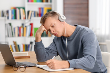 Wall Mural - Student preparing for exam at table indoors